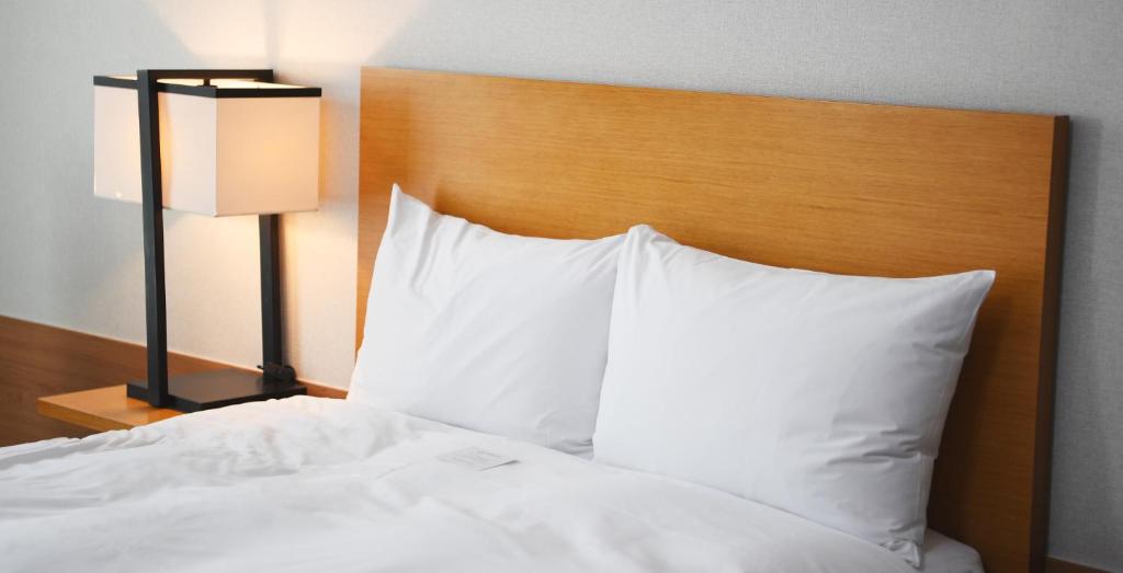 Postel nebo postele na pokoji v ubytování Hotel Laonzena