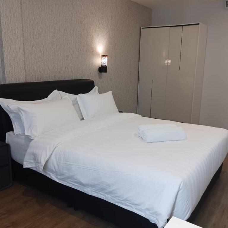 Postel nebo postele na pokoji v ubytování Soho Tabuan Kuching