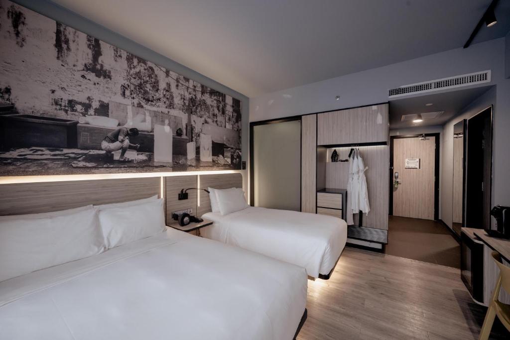 two beds in a hotel room with two beds sidx sidx sidx at The Kuala Lumpur Journal Hotel in Kuala Lumpur