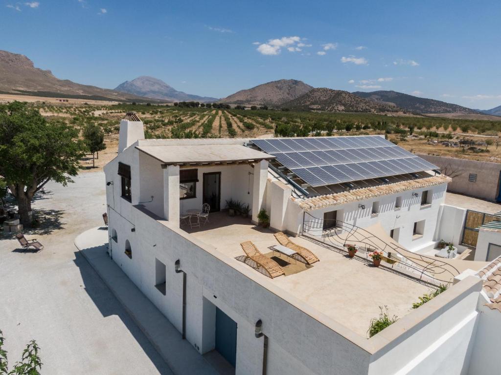 an aerial view of a house with solar panels on the roof at Cortijo Los Llanos in Huéscar