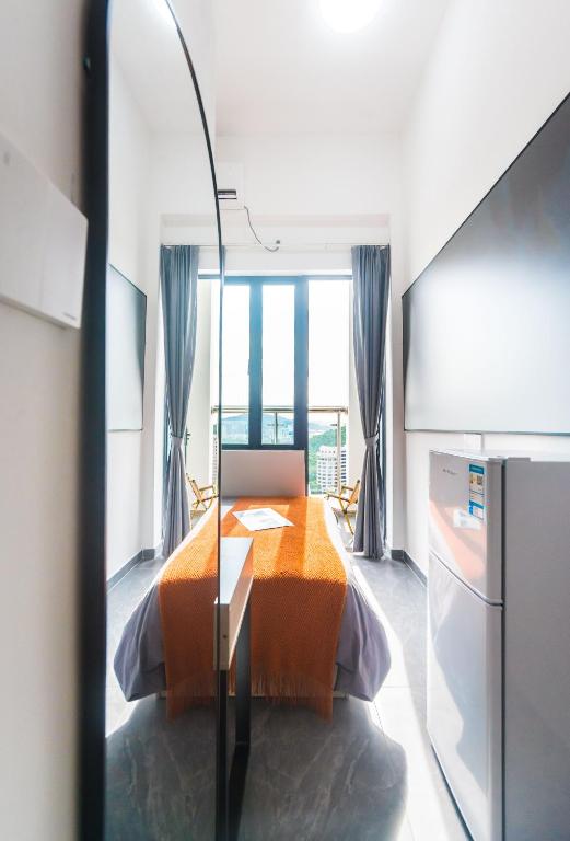 Postel nebo postele na pokoji v ubytování WESU Apartment - Shenzhen Longhua Dalang Fashion Dalang Town Branch