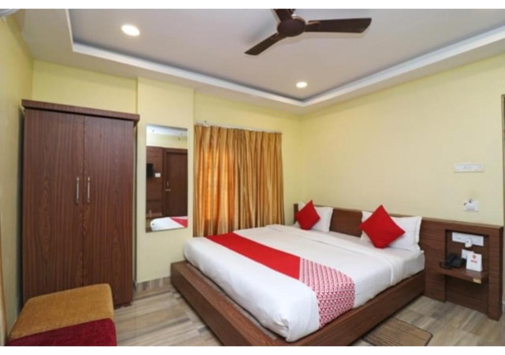 a bedroom with a large bed with red pillows at Hotel Royal Paradise ! New Digha in Digha