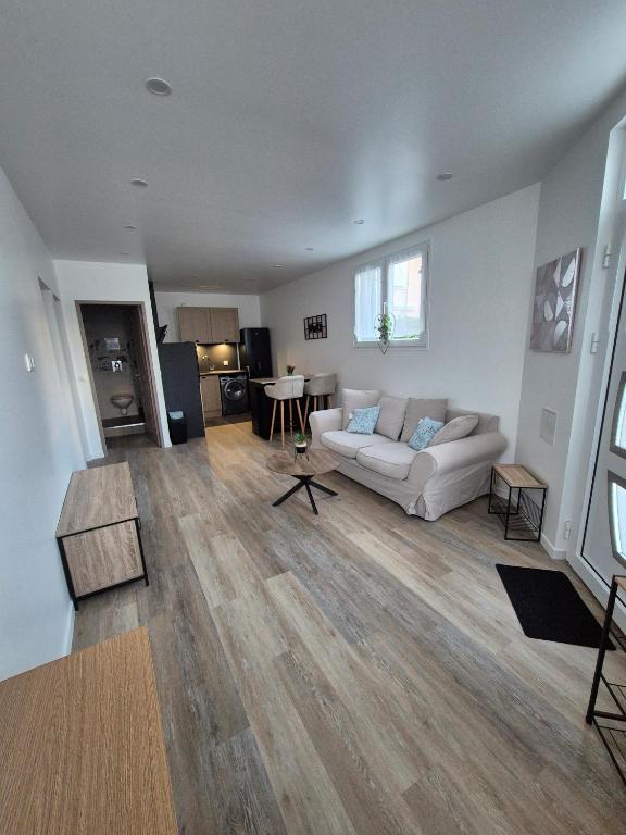 un salon avec un canapé blanc et une table dans l'établissement Appartement souplex T3 coin nuit logement entier, à Argenteuil