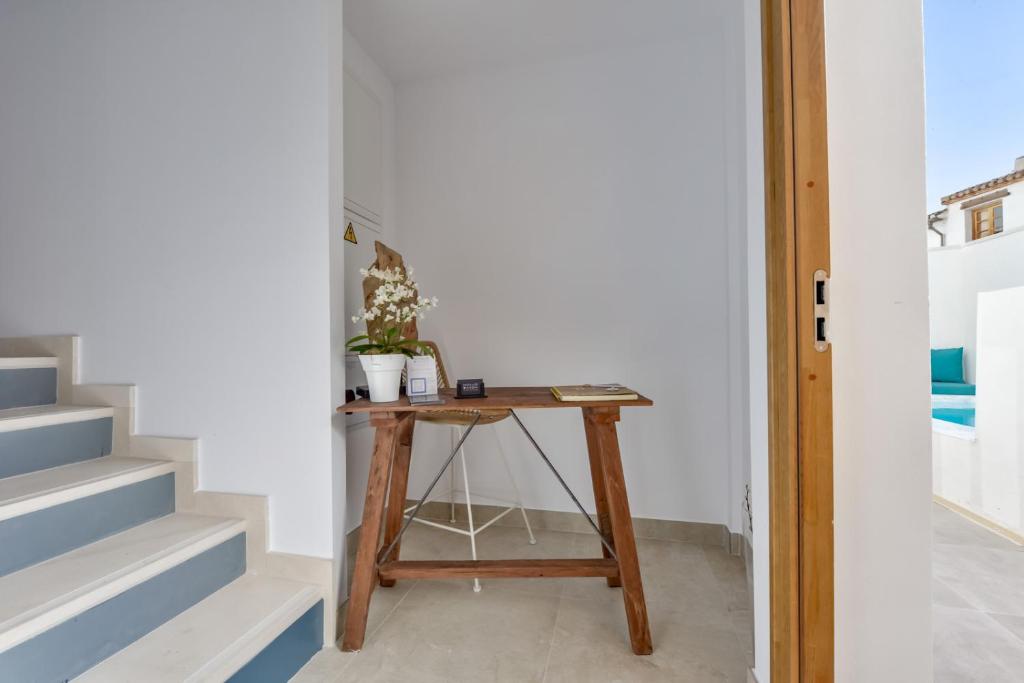a small wooden table in a room with stairs at MIMAR ALTEA ROOMS - Tranquil in Altea