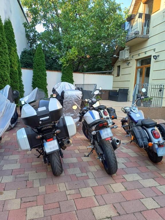 a couple of motorcycles parked in a driveway at Pannónia Rooms and Apartments in Satu Mare