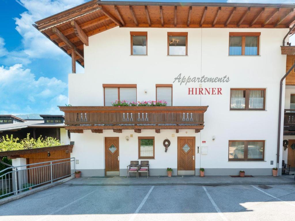 a large white building with a wooden balcony at Apartment in Tyrol near Ski Lift in Fügen