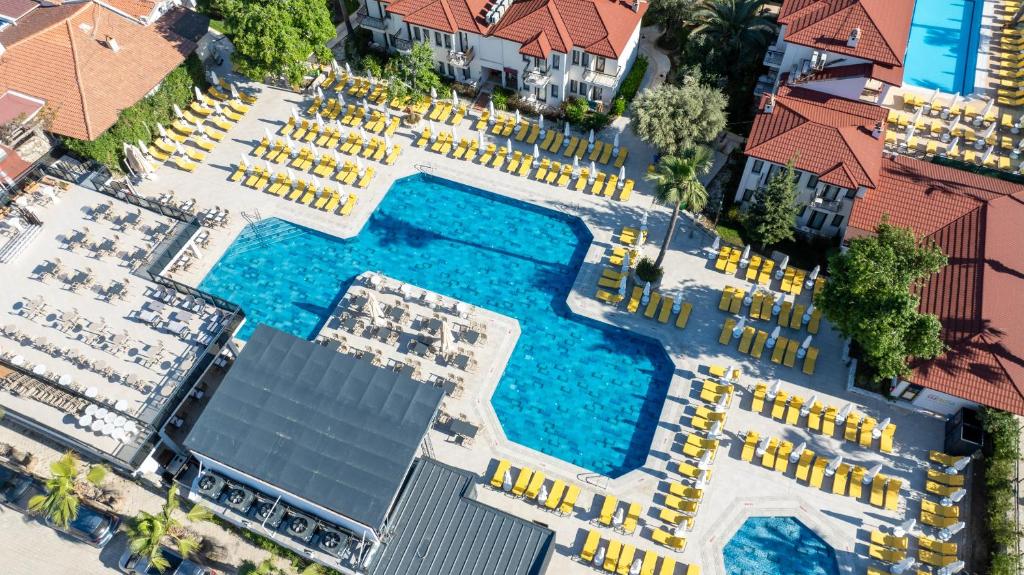 an overhead view of a swimming pool with yellow chairs at Sundia By Liberty Oludeniz in Oludeniz