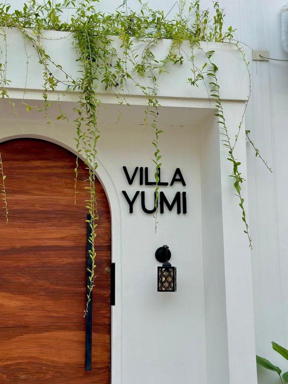 a door with the name villa yum on it at Villa Yumi in Lucena