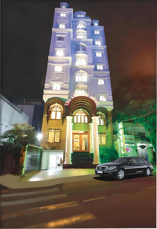 a car parked in front of a building at night at The Airport Hotel in Ho Chi Minh City