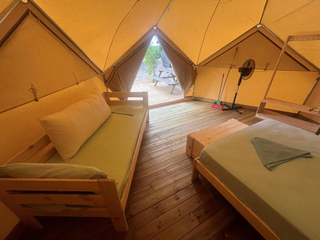 a room with two beds in a tent at Camping 3 Estrellas in Gavà