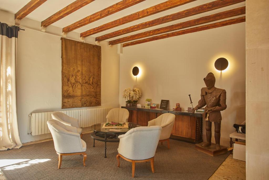 a living room with a statue of a man at Virrey Finca Hotel in Inca
