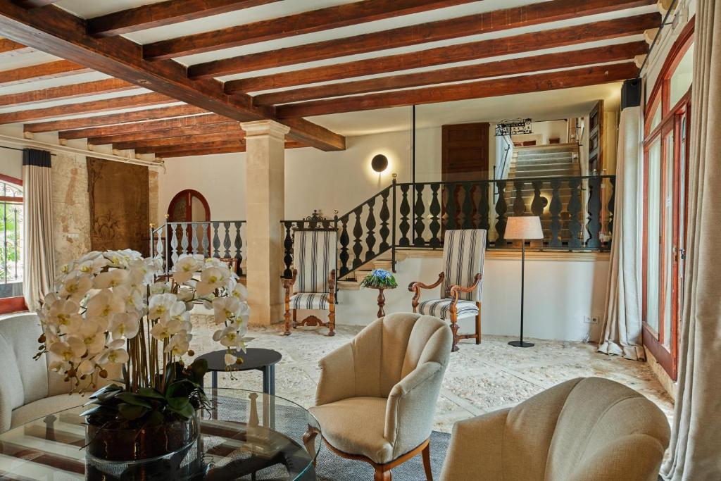 a living room with chairs and a table at Virrey Finca Hotel in Inca