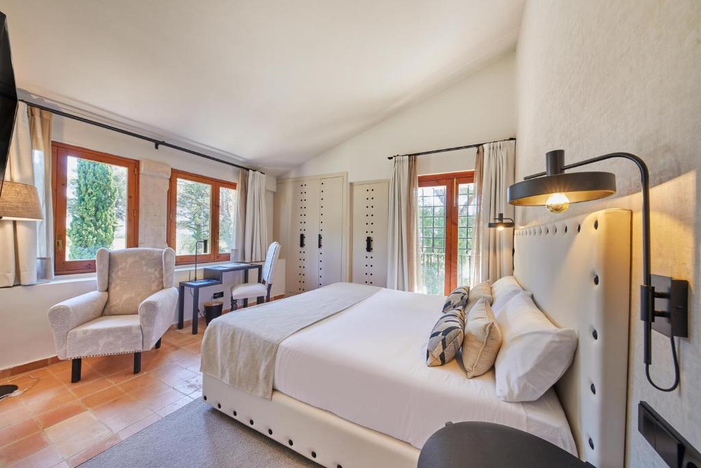 a bedroom with a bed and a table and chairs at Virrey Finca Hotel in Inca