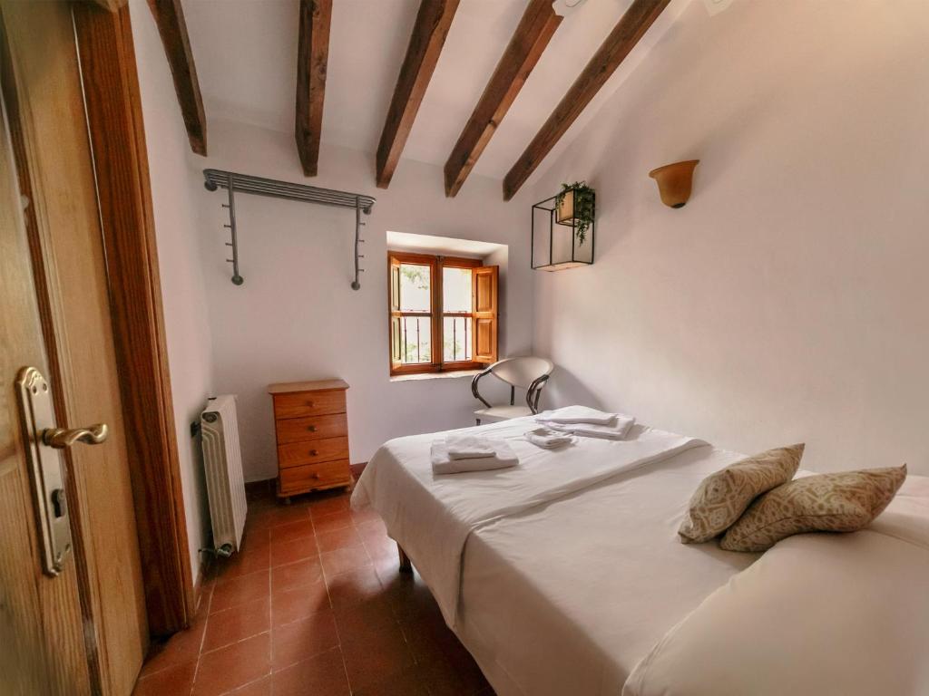 a bedroom with a bed in a room with a window at Petit Hotel Hostatgeria La Victoria in Alcudia