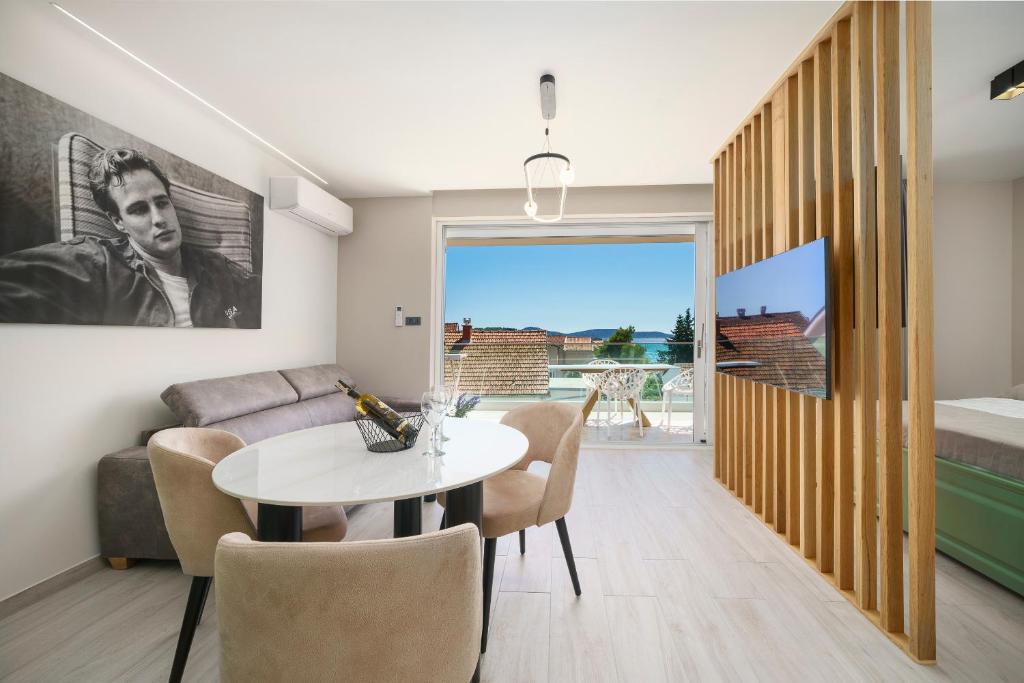 a living room with a table and a couch at Luxury Apartments Maja Vodice in Srima