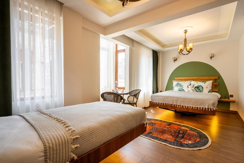 a bedroom with two beds and a green headboard at York House İstanbul in Istanbul