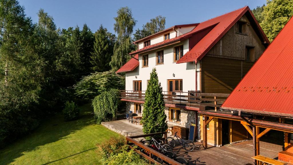 an image of a house with a red roof at Gościniec Skalite in Godziszka