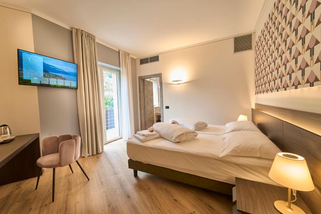 Postel nebo postele na pokoji v ubytování Hotel Villa Cuserina