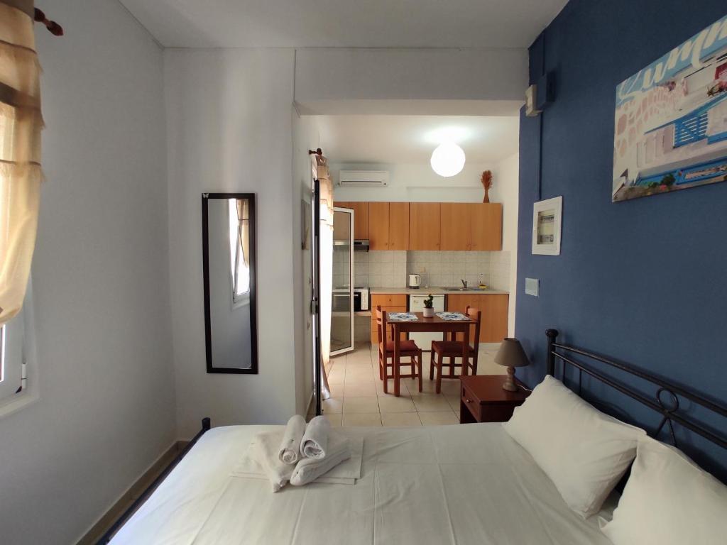 a bedroom with a bed and a dining room at Chalkidonos in Heraklio Town