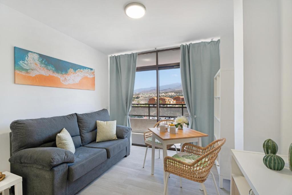 a living room with a couch and a table at Apto Sasha Los Cristianos in Arona