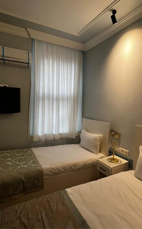 Postel nebo postele na pokoji v ubytování Bali Star City Hotel