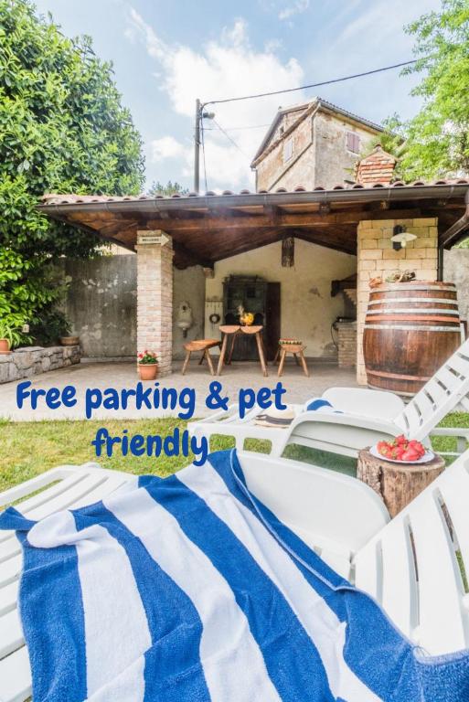a backyard party with a blue and white striped blanket at Apartments Villa Sušanj in Matulji