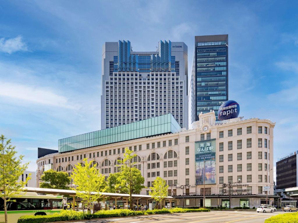 a building in a city with tall buildings at Swissotel Nankai Osaka in Osaka