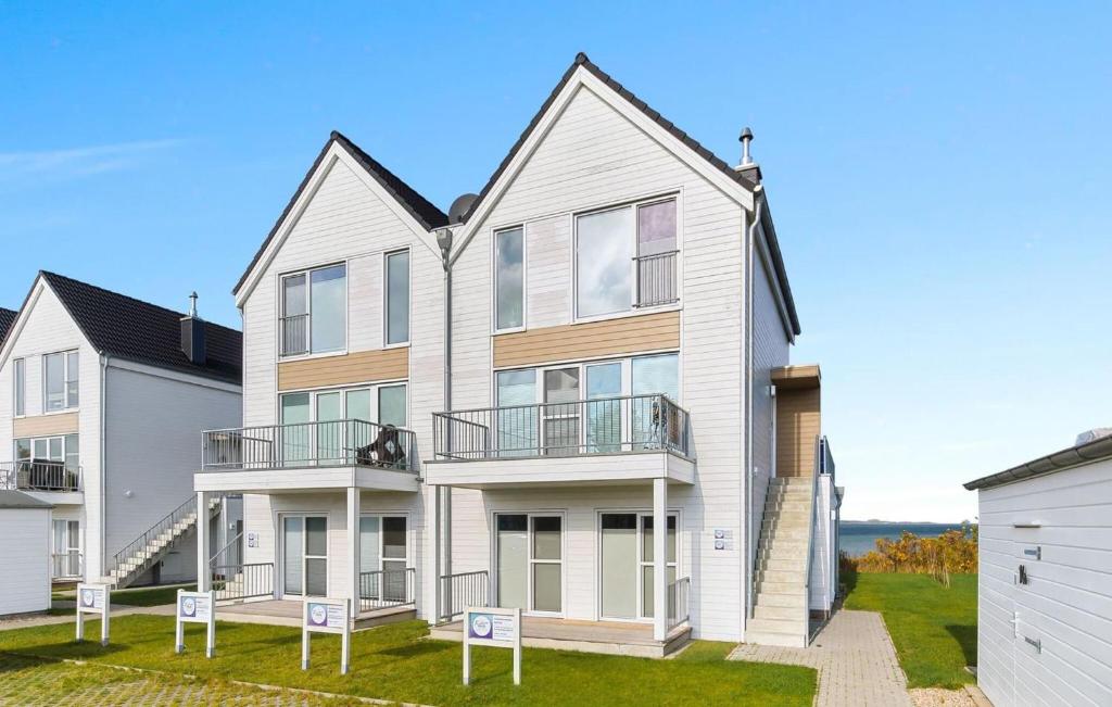 a large white house with two balconies at Baltica in Olpenitz