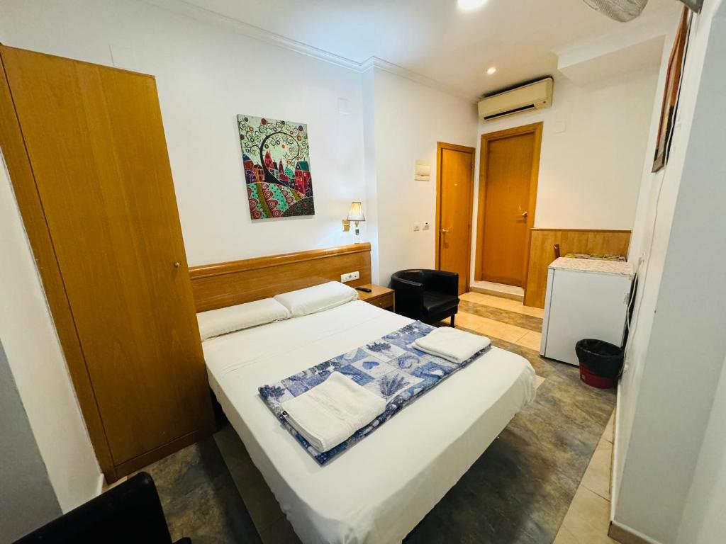 Postel nebo postele na pokoji v ubytování Hostal Mont Thabor