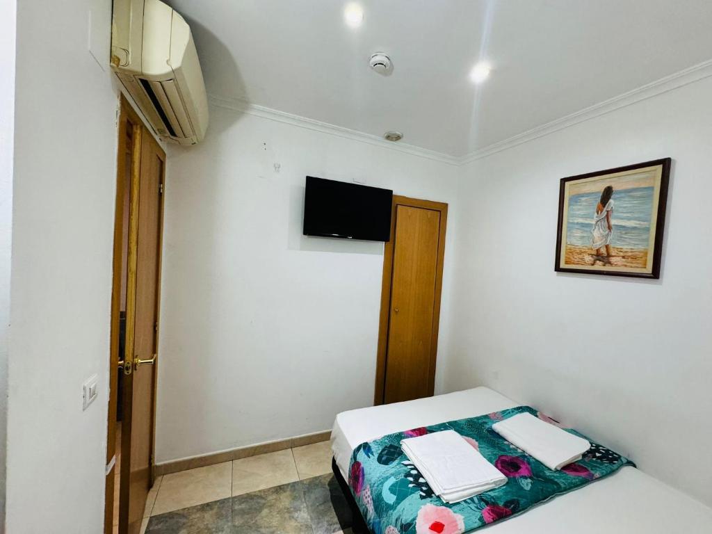 Postel nebo postele na pokoji v ubytování Hostal Mont Thabor