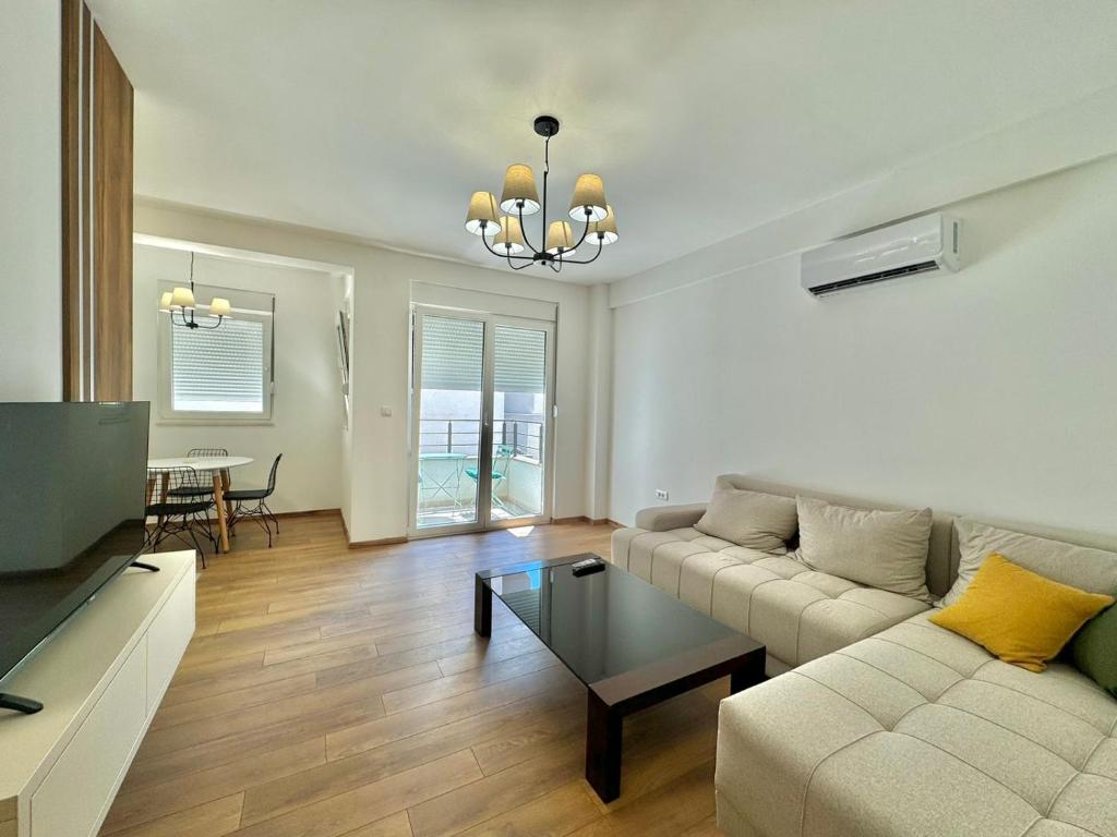 a living room with a couch and a table at One bedroom Apartment 777 in Budva