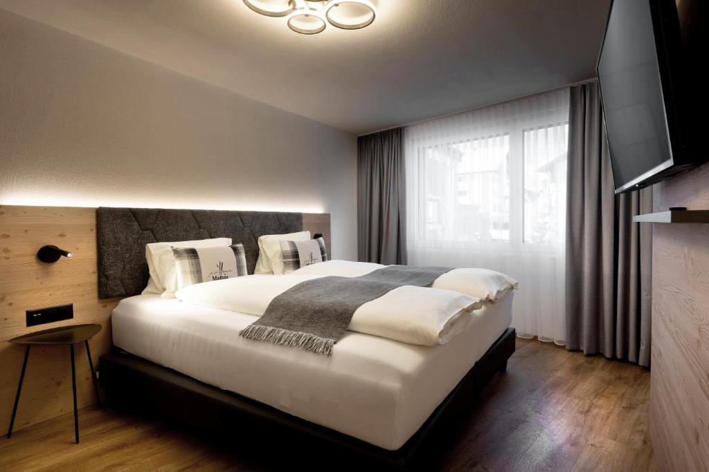 Ένα ή περισσότερα κρεβάτια σε δωμάτιο στο Ferienwohnung TURNA Malbun