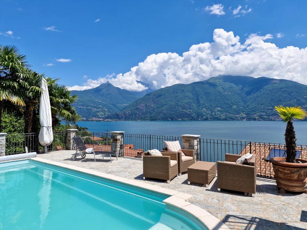 a swimming pool with a view of a lake and mountains at Oasi Ulivi in San Siro