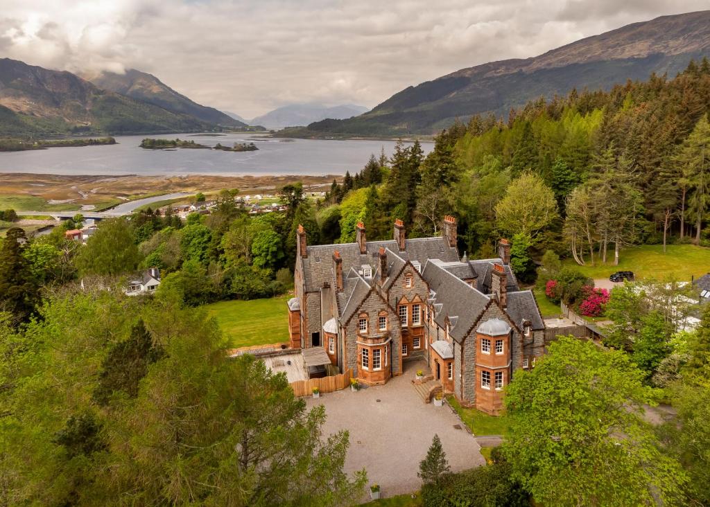 an aerial view of a large house with a lake at Glencoe House in Glencoe