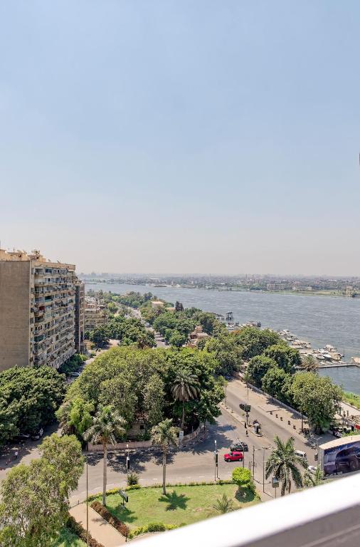 a view of a city with a river and trees at VESTA Nile View Residence - Maadi in Cairo