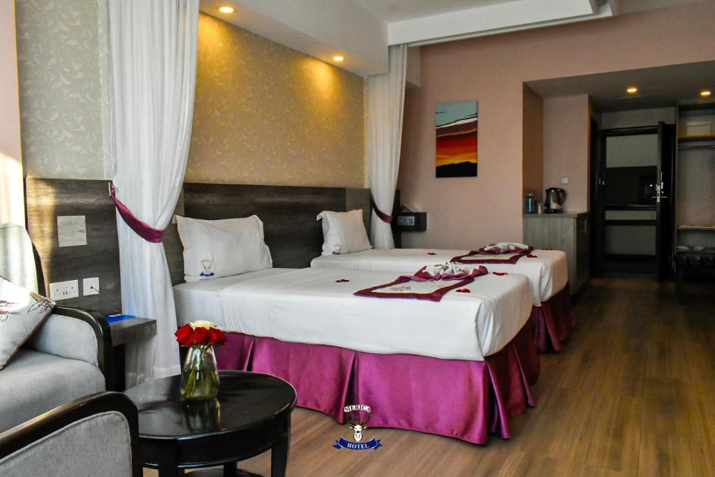 Postel nebo postele na pokoji v ubytování Merica Hotel