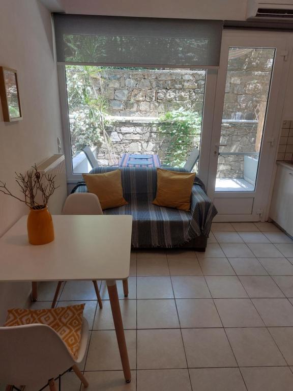a living room with a couch and a table at Samos Cozy Apartment in Samos