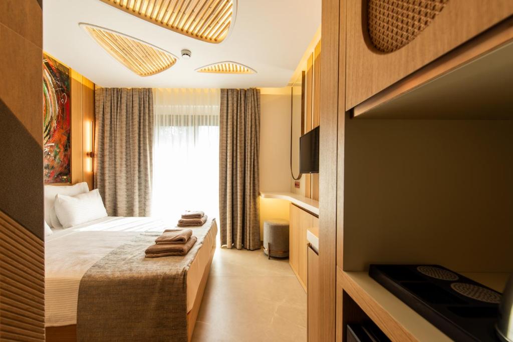 Postel nebo postele na pokoji v ubytování Casa Mimas Hotel