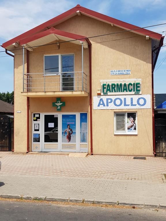 a building with a sign that reads farm market apollo at Vilele Brise de Mer in 2 Mai
