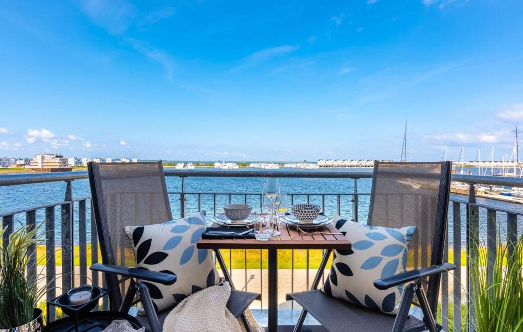 a table and chairs on a balcony overlooking the water at Hafendiamant in Olpenitz
