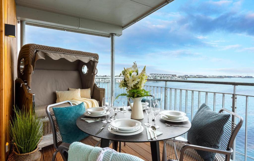 a table on a balcony with a view of the water at Ms Admiral in Olpenitz