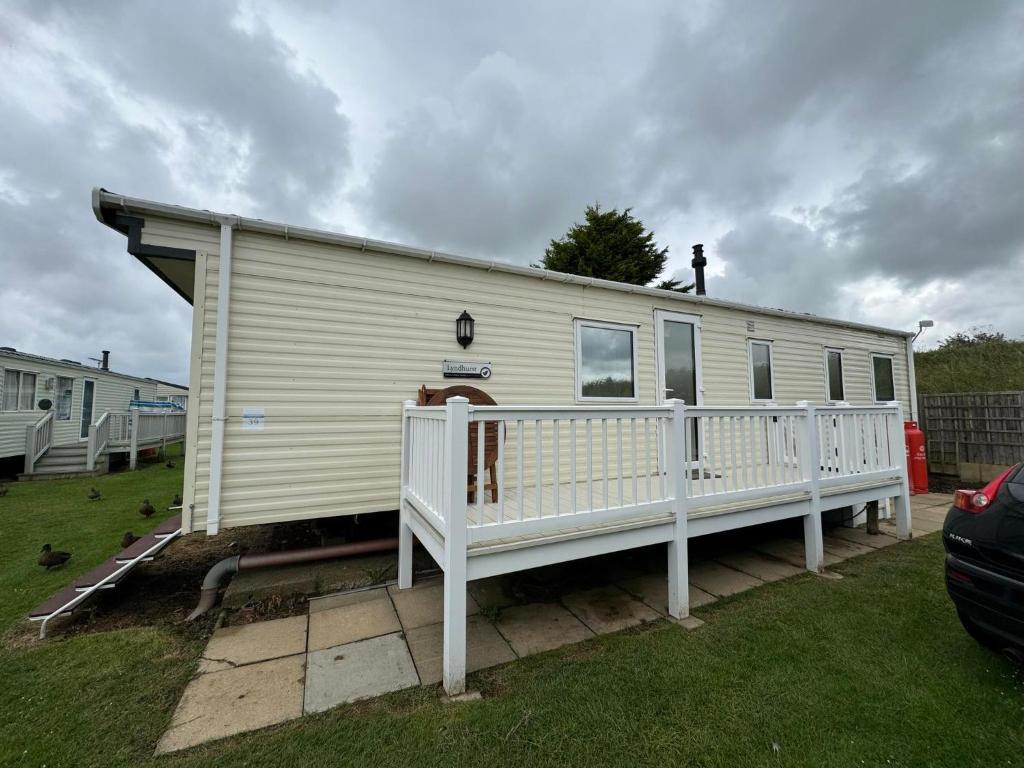 a mobile home with a man on top of it at Family 3 Bedroom Caravan at Heacham Beach in Hunstanton