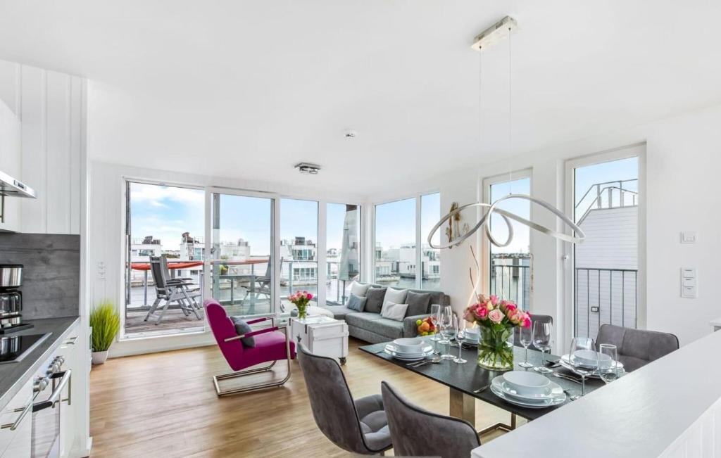 a kitchen and living room with a table and chairs at Ankerplatz19B in Olpenitz