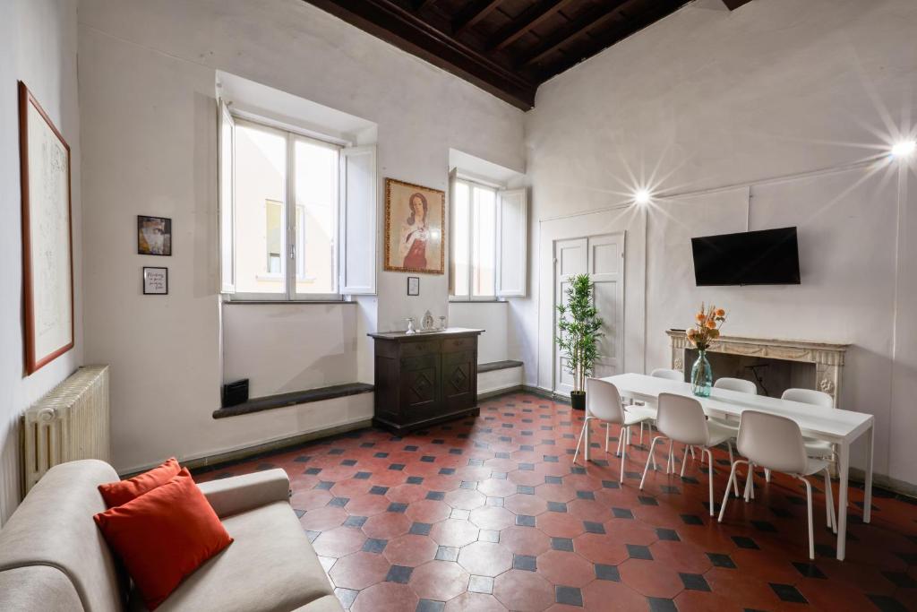 a living room with a table and chairs and a fireplace at De Bardi - Beautiful Home near Ponte Vecchio in Florence