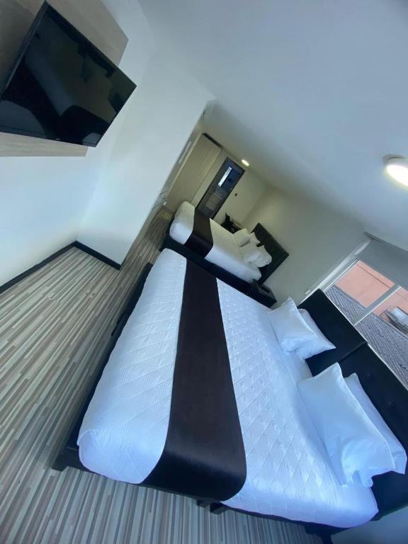 Postel nebo postele na pokoji v ubytování Hotel AMBAR KING