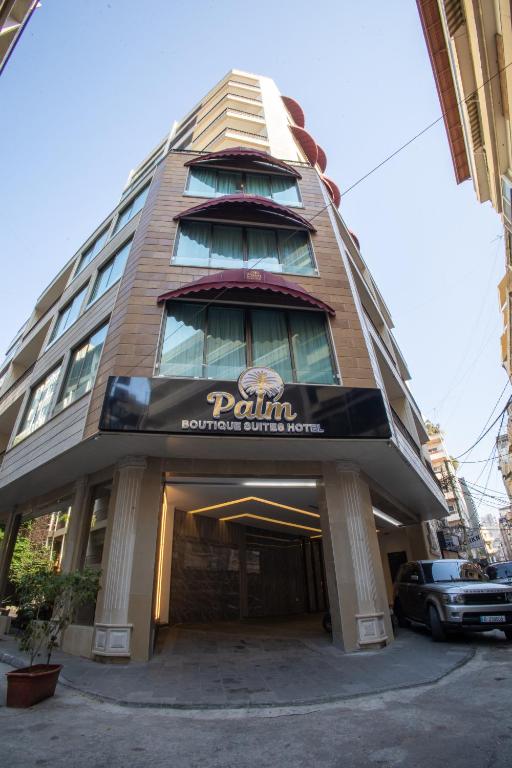 a building with a sign on the front of it at Palm Boutique Suites Hotel in Beirut