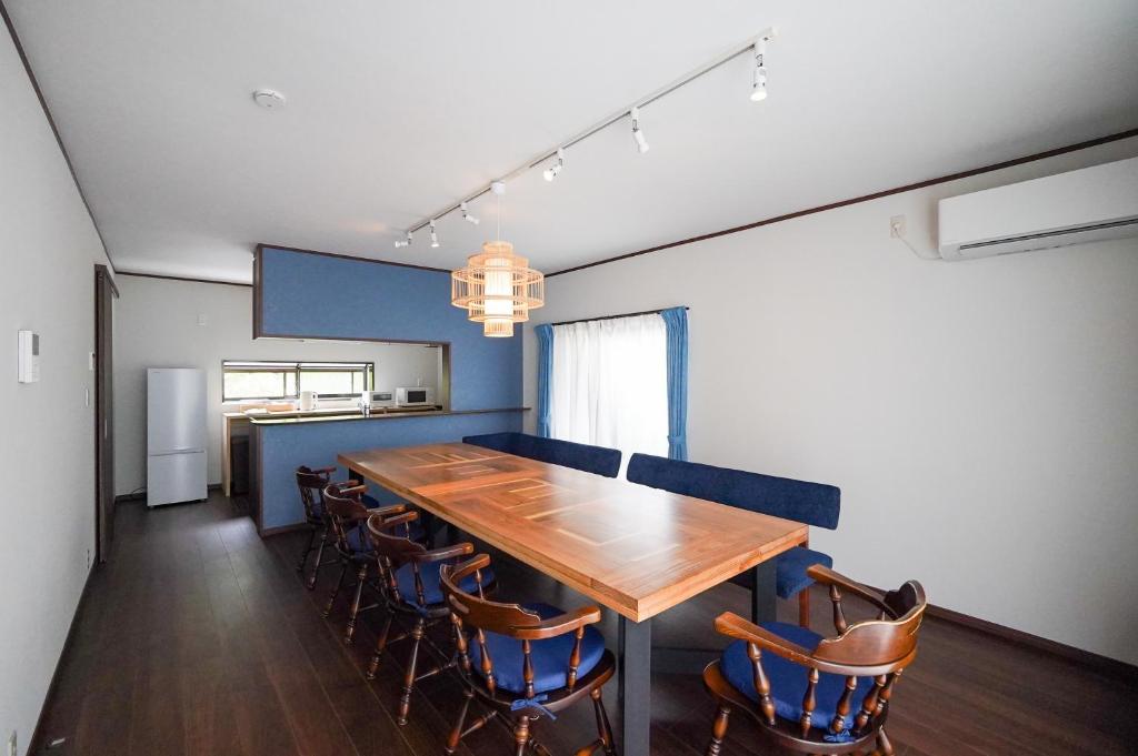 a dining room with a wooden table and chairs at Nikko Holiday Home Sumica in Nikko