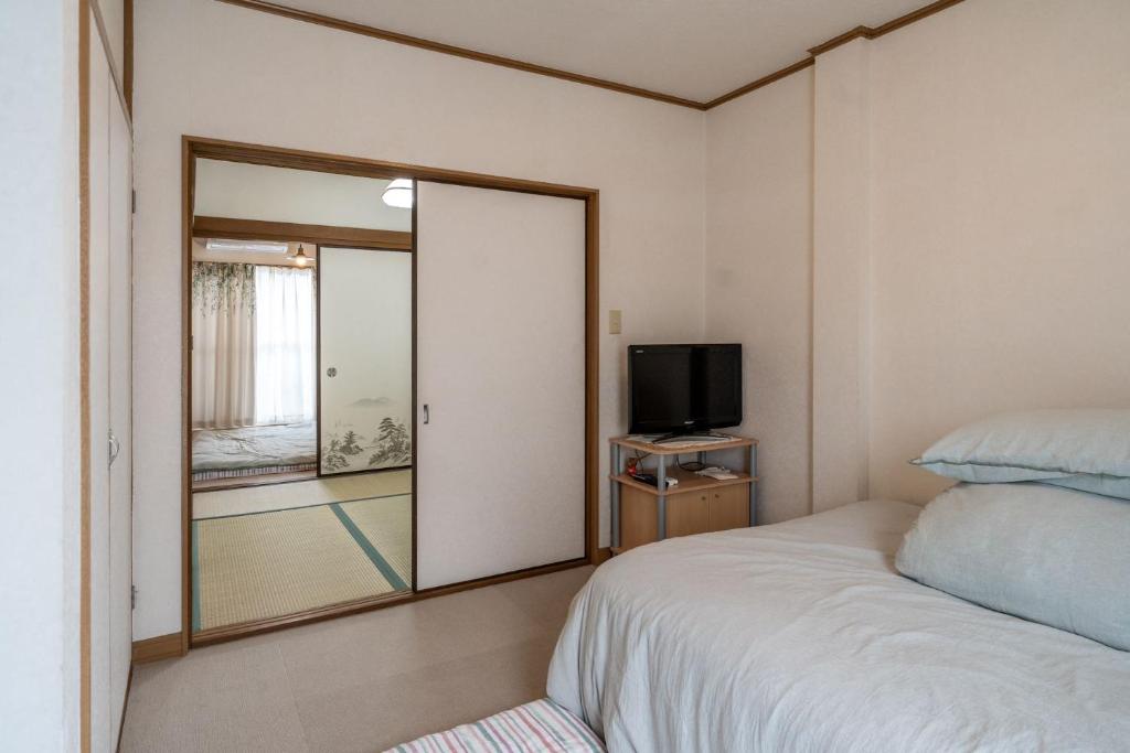 Postel nebo postele na pokoji v ubytování 易居の宿