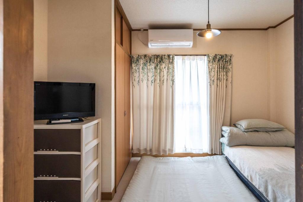 Postel nebo postele na pokoji v ubytování 易居の宿