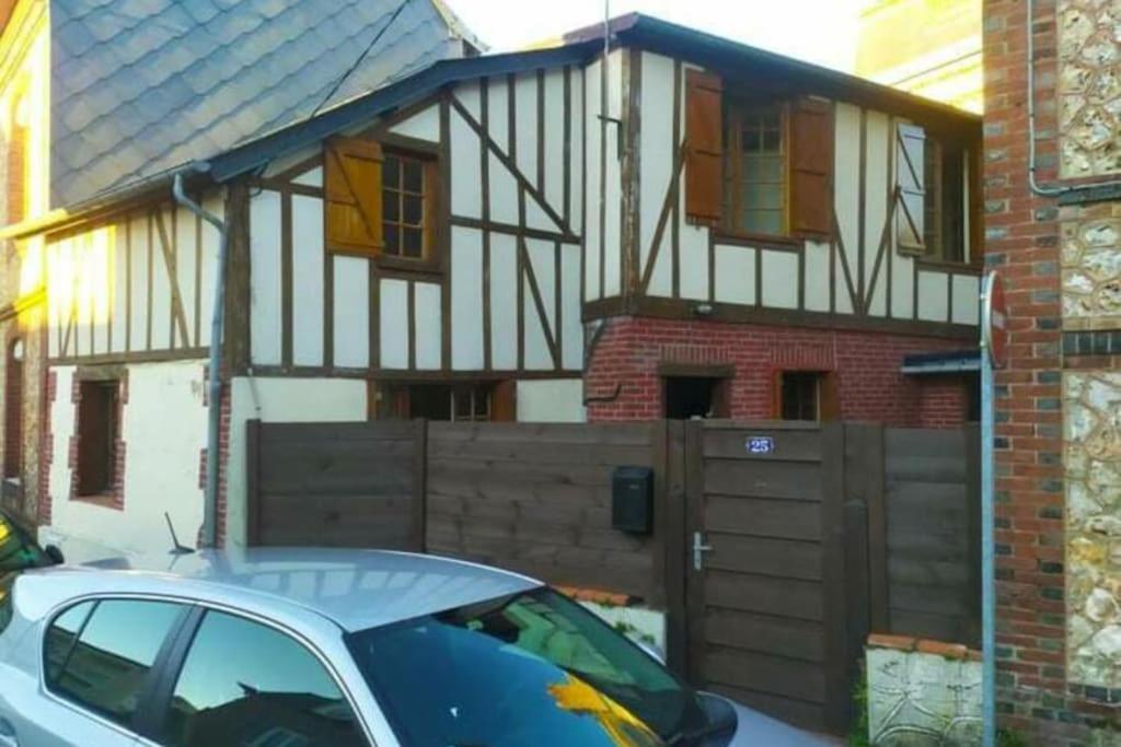 a house with a car parked in front of it at Charmante maison normande ! in Pont-Audemer